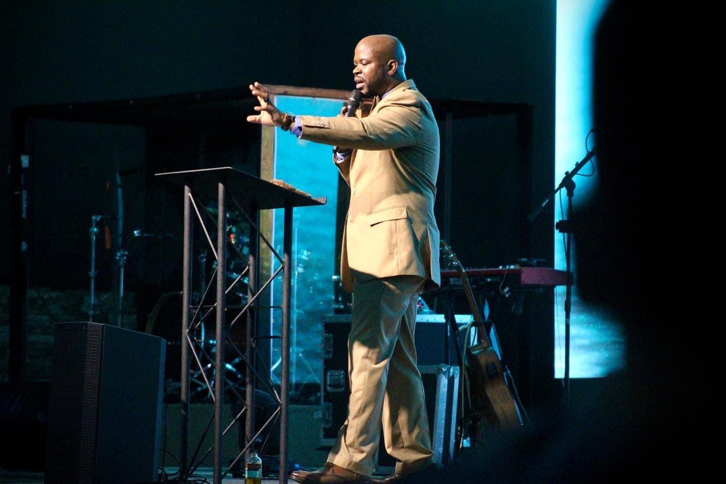 Lenell speaking on stage